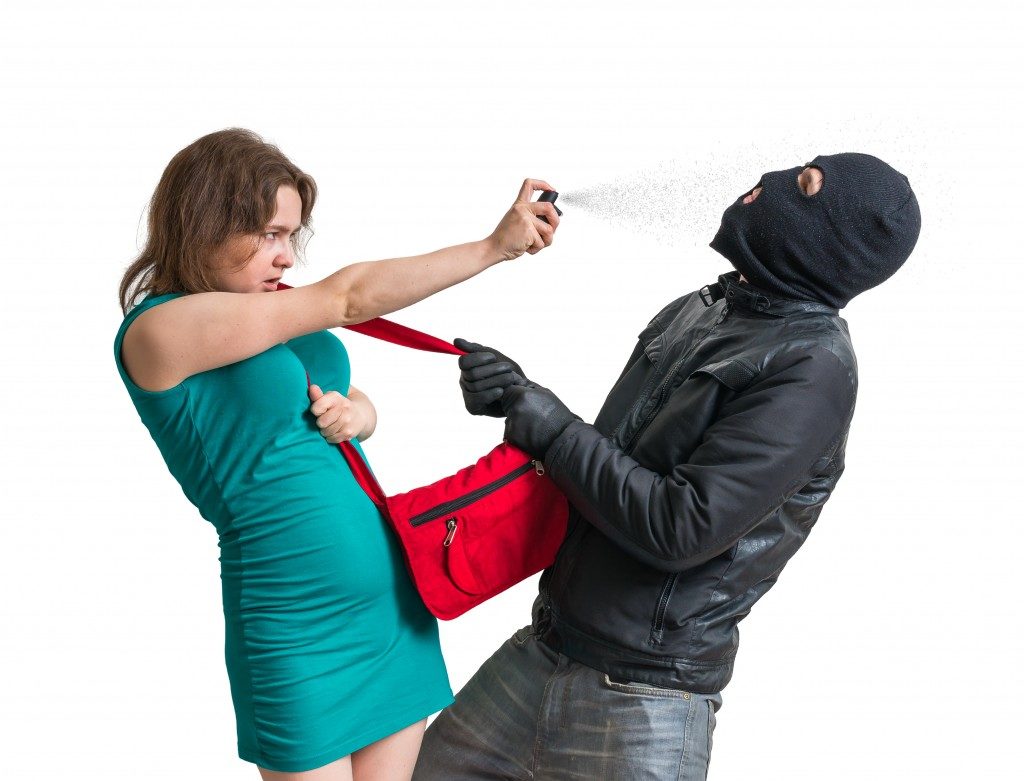 woman using pepper spray