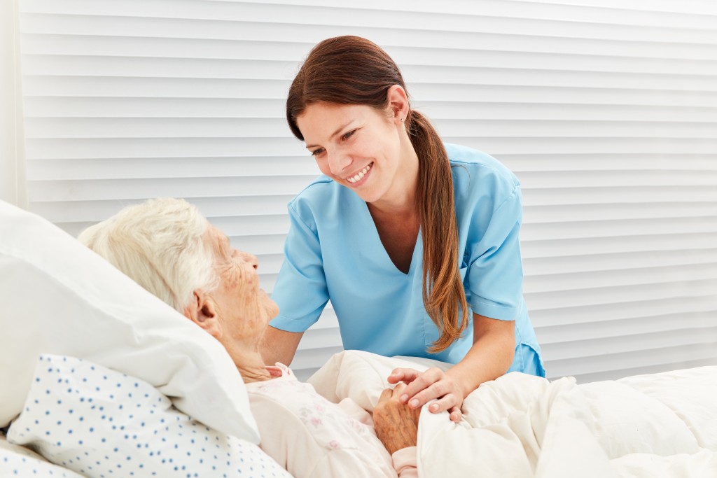 Female nurse caring for elderly