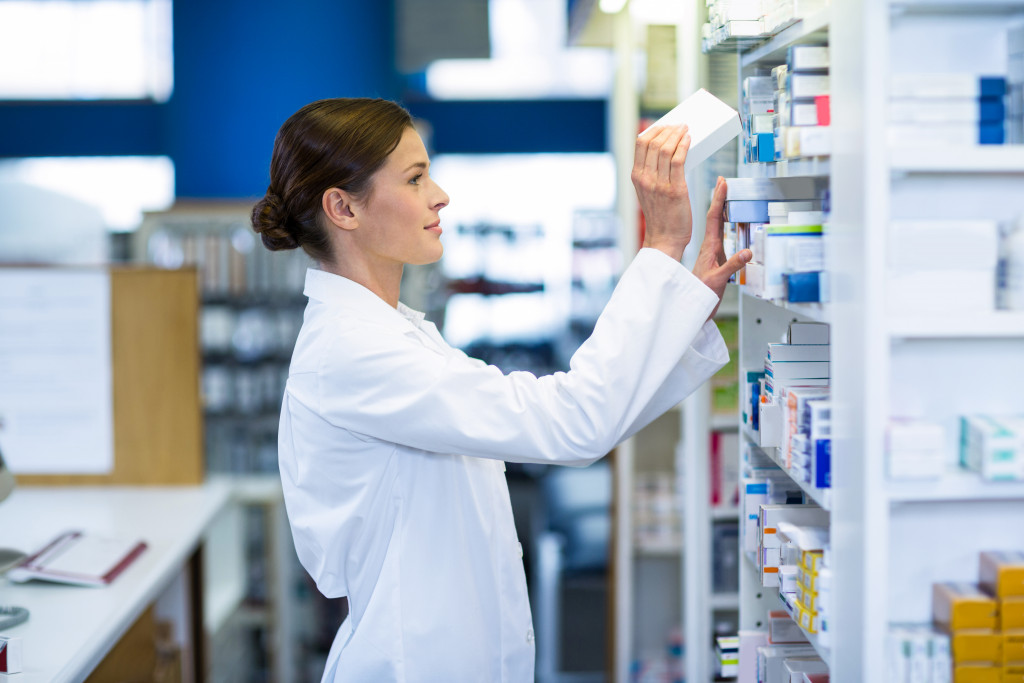pharmacist stocking up the shelves 