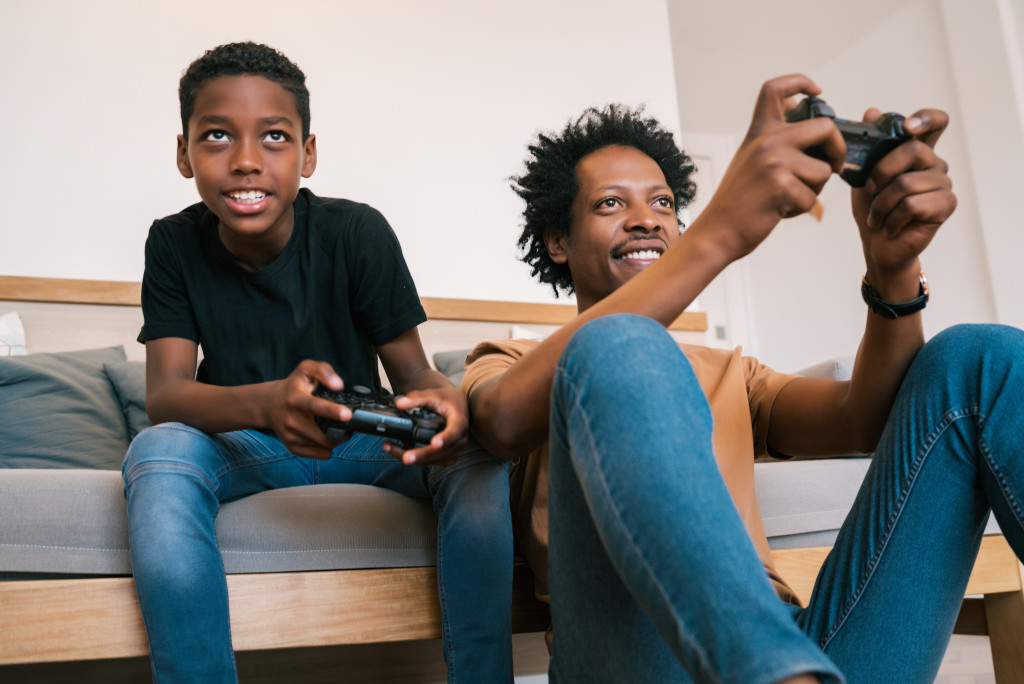 father and son playing video games