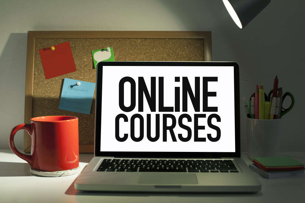 online courses concept on laptop with orange mug